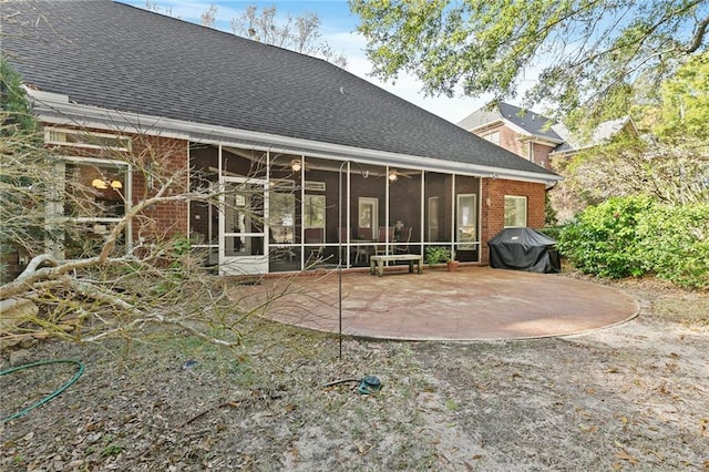 rear view of property with a sunroom and a patio