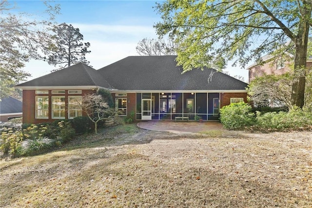 rear view of property featuring a patio area and a sunroom