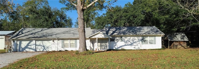 single story home featuring a front yard and a garage