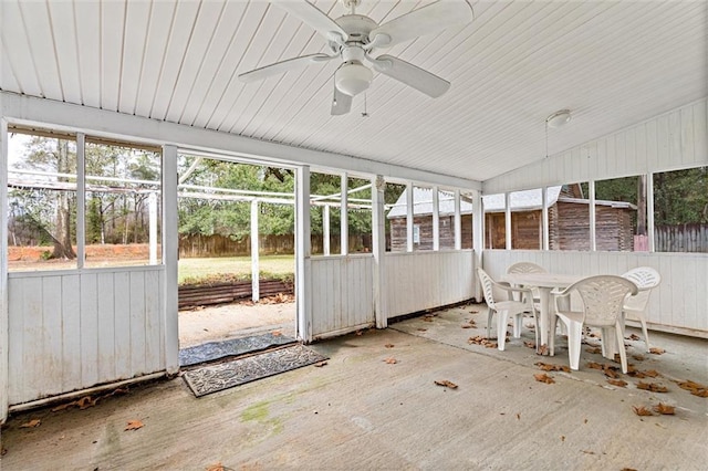 unfurnished sunroom featuring ceiling fan and vaulted ceiling