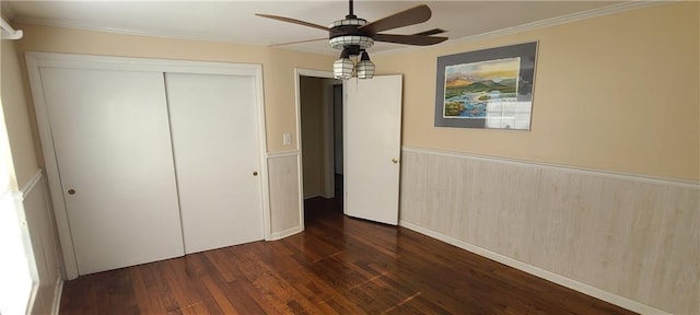 unfurnished bedroom with ceiling fan, crown molding, a closet, and dark hardwood / wood-style floors