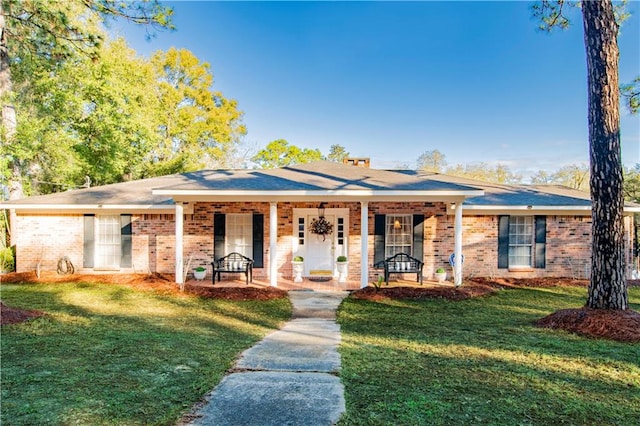 ranch-style home with a porch and a front yard