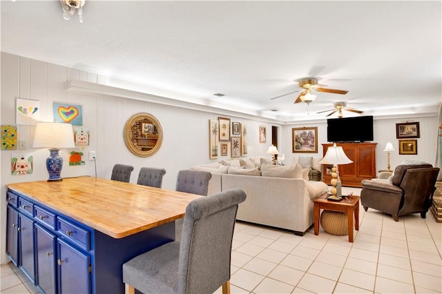 dining space featuring ceiling fan and light tile patterned flooring