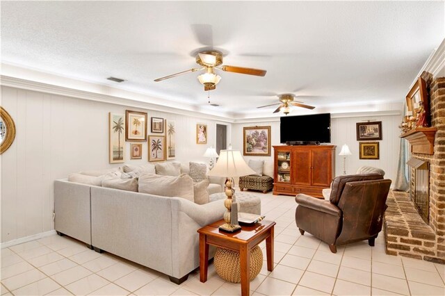 living room with light tile patterned floors, a brick fireplace, and ceiling fan