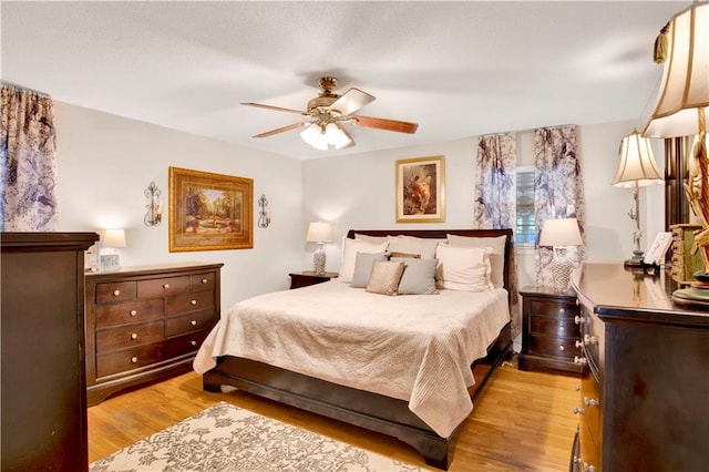 bedroom with ceiling fan and light hardwood / wood-style flooring