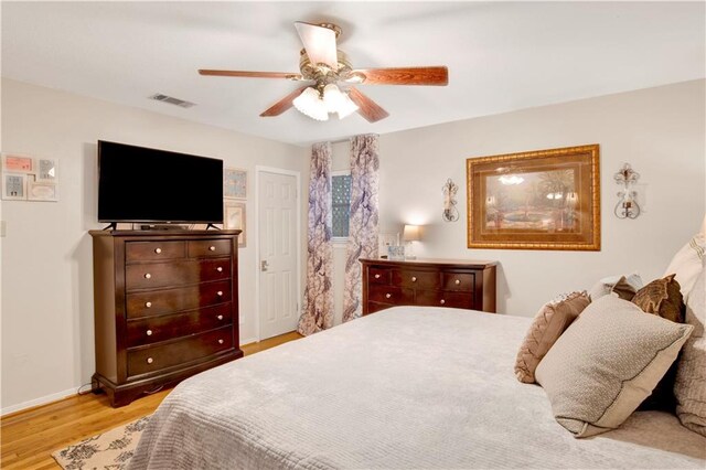 bedroom with ceiling fan and light hardwood / wood-style flooring