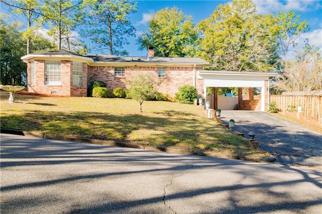 ranch-style home with a carport and a front yard