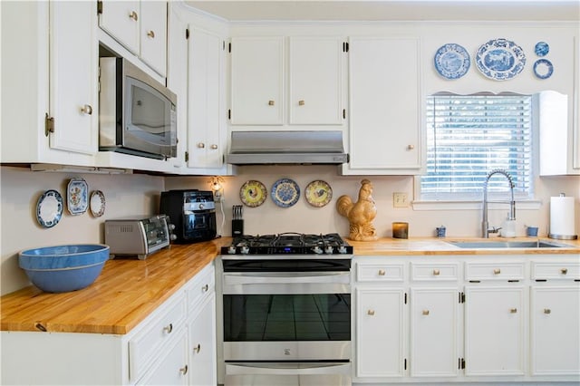 kitchen with sink, stainless steel appliances, white cabinetry, and range hood