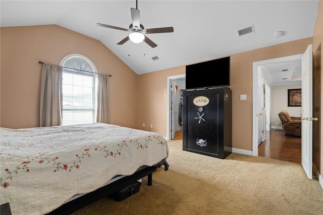 carpeted bedroom with vaulted ceiling and ceiling fan