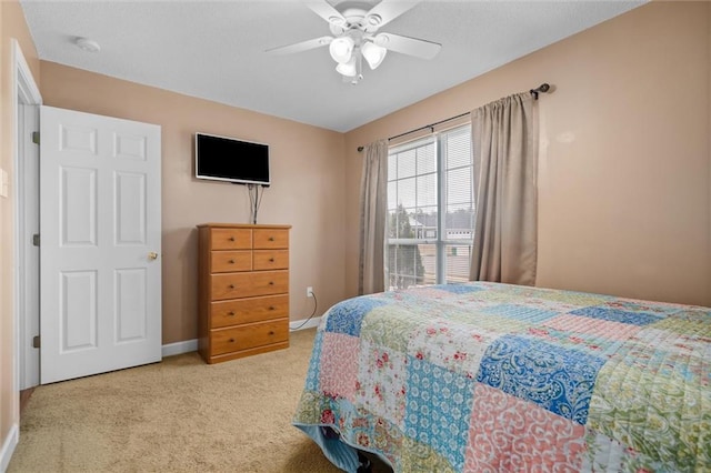 bedroom featuring light carpet and ceiling fan