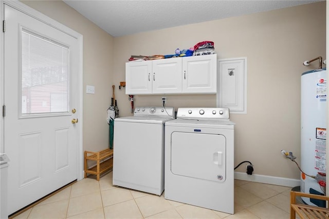 laundry room with independent washer and dryer, gas water heater, cabinets, and light tile patterned flooring