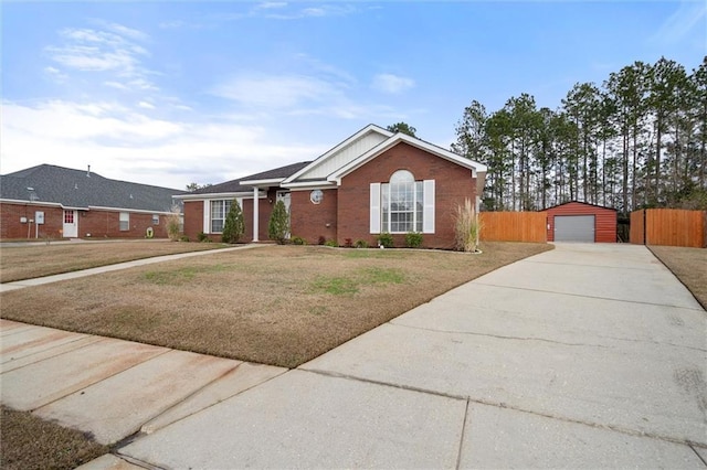 single story home featuring a garage, an outdoor structure, and a front lawn