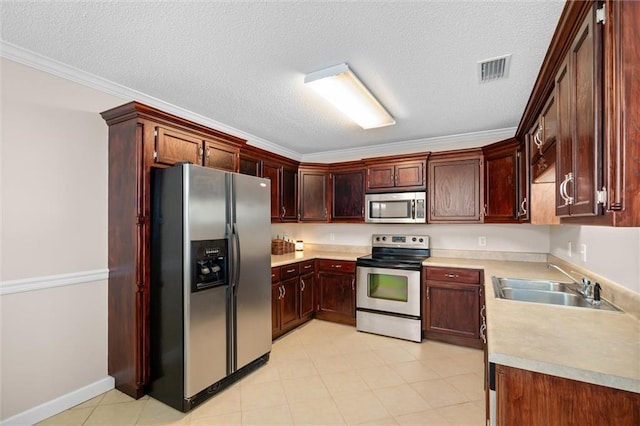 kitchen featuring crown molding, stainless steel appliances, sink, and a textured ceiling