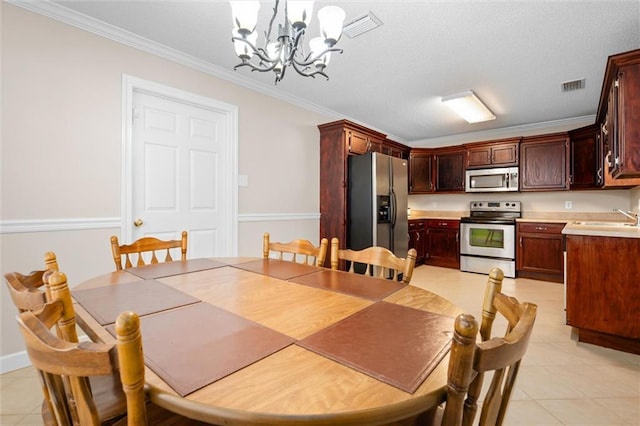 tiled dining room featuring ornamental molding, sink, and a notable chandelier