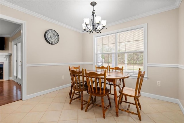 dining room featuring an inviting chandelier, ornamental molding, and light tile patterned floors