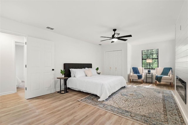bedroom featuring visible vents, light wood-type flooring, a closet, and ceiling fan