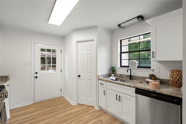 kitchen with light wood-type flooring, stainless steel dishwasher, white cabinets, and a sink
