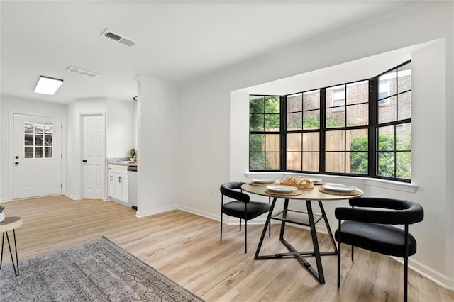 dining room featuring light wood-style flooring, breakfast area, and plenty of natural light