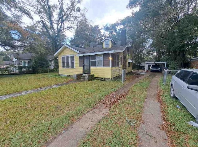 view of front facade featuring a sunroom and a front yard