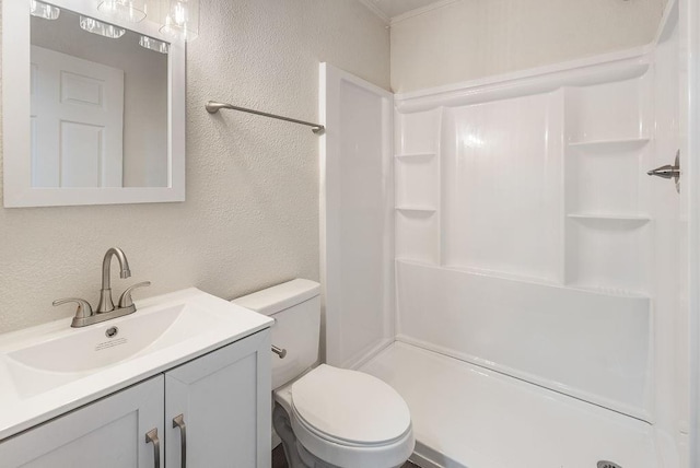 bathroom with a shower, vanity, and toilet