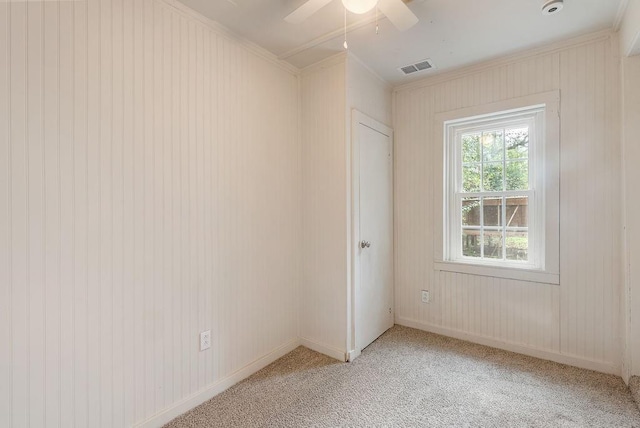 carpeted empty room featuring crown molding and ceiling fan