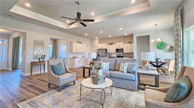 2295 Nadine Ln, Mobile, AL 36695 - living area with a tray ceiling, light wood-style floors, a ceiling fan, recessed lighting, and ornamental molding