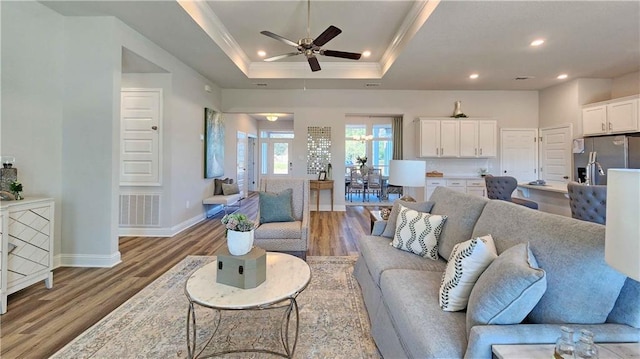 2295 Nadine Ln, Mobile, AL 36695 - living room featuring wood finished floors, recessed lighting, ceiling fan, a tray ceiling, and ornamental molding