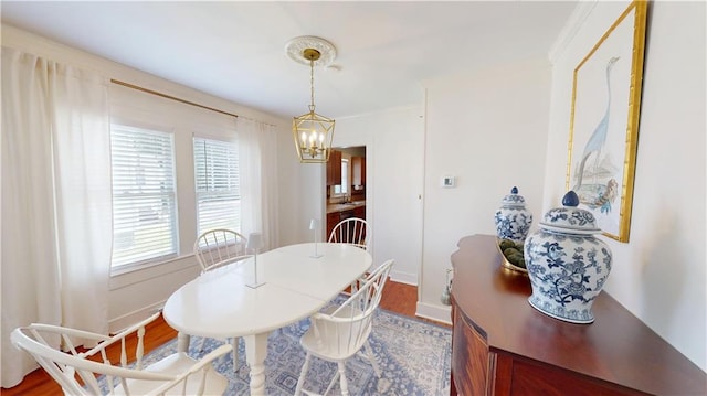 21 Crenshaw St, Mobile, AL 36606 - dining area with a chandelier, wood finished floors, and baseboards
