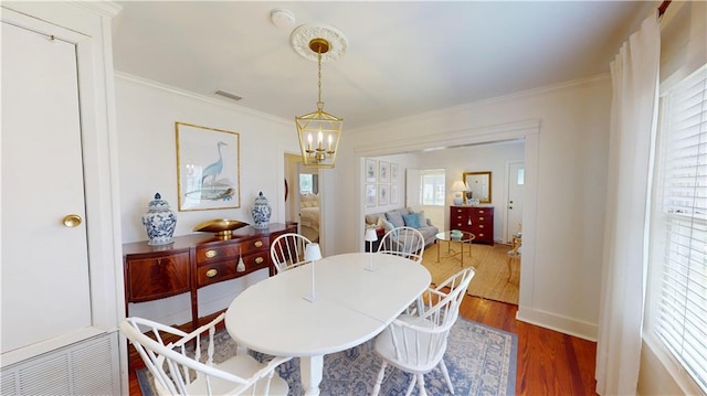 21 Crenshaw St, Mobile, AL 36606 - dining area with wood finished floors, a chandelier, and ornamental molding