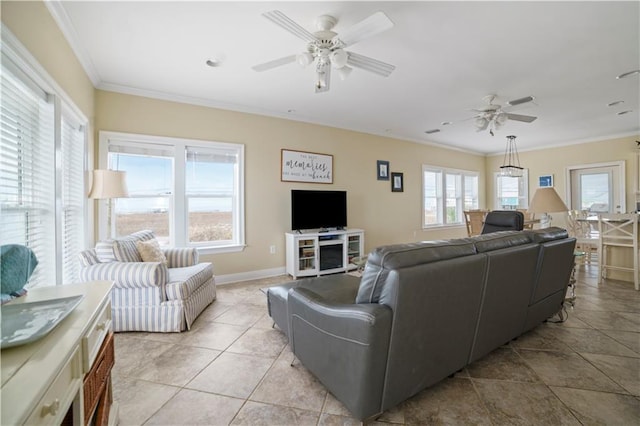 living room featuring ornamental molding, light tile patterned floors, baseboards, and a ceiling fan