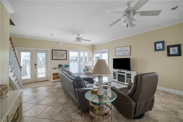 living area featuring french doors, crown molding, stairway, and baseboards