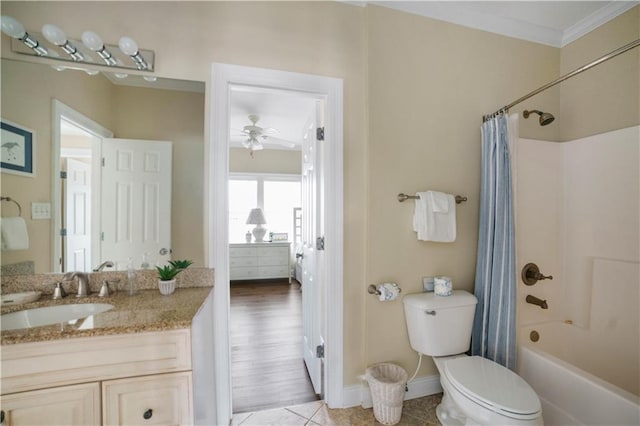 full bathroom with shower / tub combo, a ceiling fan, toilet, crown molding, and vanity