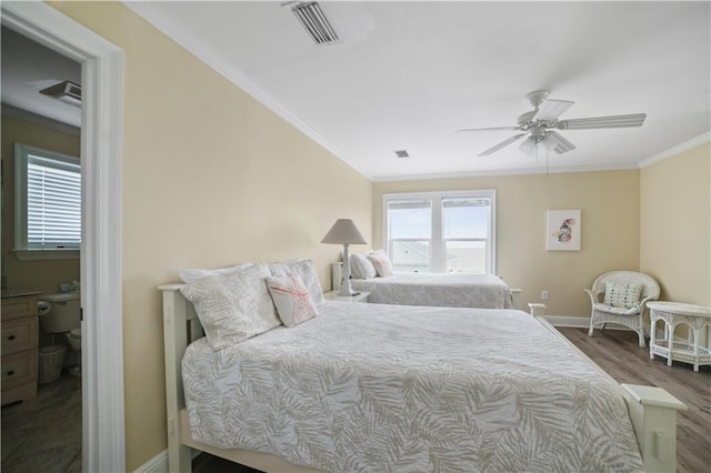 bedroom featuring wood finished floors, visible vents, crown molding, and multiple windows