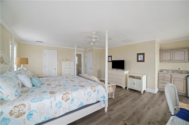 bedroom featuring baseboards, dark wood-style flooring, indoor wet bar, and crown molding