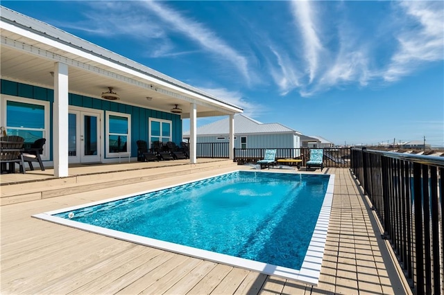 view of pool featuring a ceiling fan, a fenced in pool, and french doors