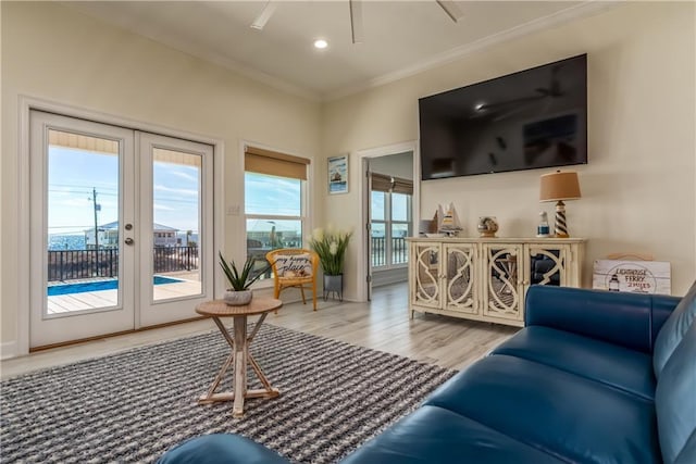 living room with recessed lighting, french doors, wood finished floors, and ornamental molding