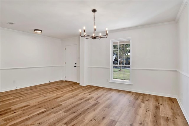 unfurnished dining area with a notable chandelier, crown molding, and light wood-type flooring