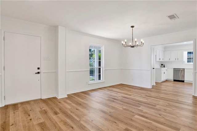 5912 Cansler Dr, Mobile, AL 36609 - unfurnished living room featuring a chandelier, plenty of natural light, light wood-type flooring, crown molding, and baseboards
