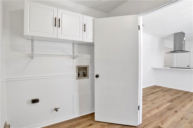 washroom featuring washer hookup, hookup for a gas dryer, light hardwood / wood-style flooring, and cabinets