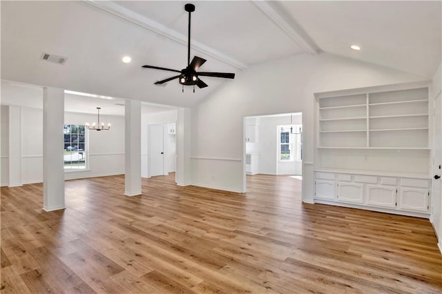 unfurnished living room with lofted ceiling with beams, ceiling fan with notable chandelier, and light hardwood / wood-style floors