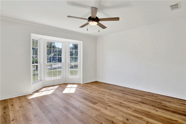 unfurnished room with light hardwood / wood-style flooring, ornamental molding, and ceiling fan