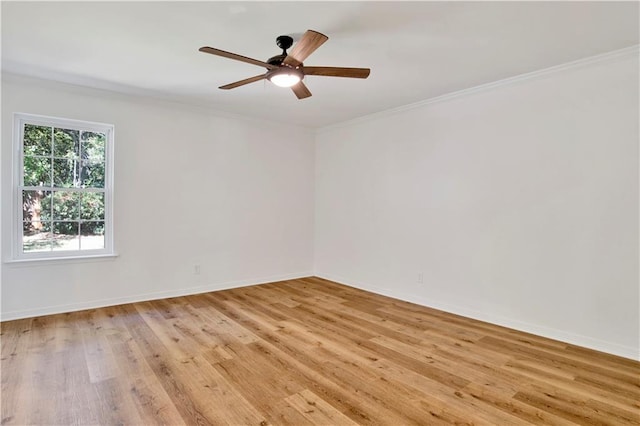 empty room featuring crown molding, light hardwood / wood-style flooring, and ceiling fan