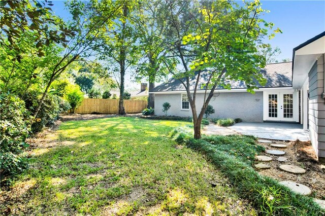 view of yard with a patio area and french doors