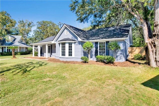 single story home featuring a porch and a front yard