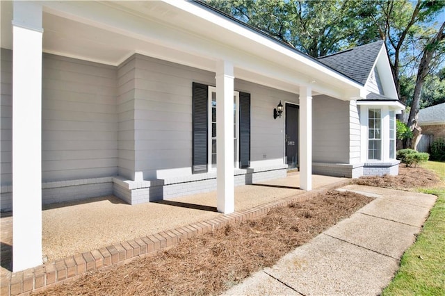 5912 Cansler Dr, Mobile, AL 36609 - doorway to property with roof with shingles and a porch
