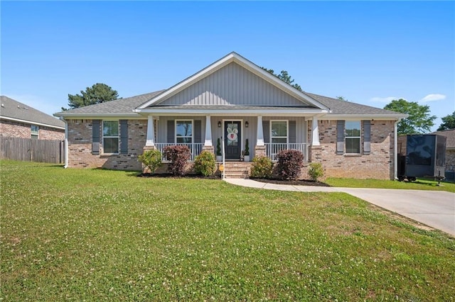 9412 Fox Hunter Ct, Semmes, AL 36575 - view of front of house featuring a front lawn, brick siding, a porch, and fence