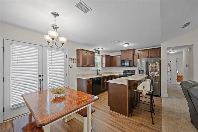 9412 Fox Hunter Ct, Semmes, AL 36575 - kitchen with black appliances, a sink, visible vents, and light countertops