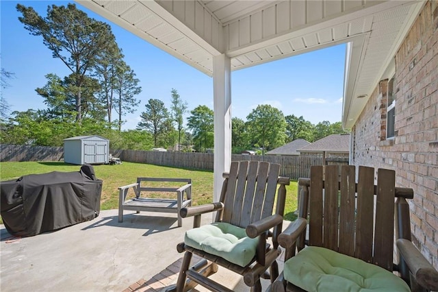 9412 Fox Hunter Ct, Semmes, AL 36575 - view of patio featuring a fenced backyard, a storage unit, an outdoor structure, and area for grilling
