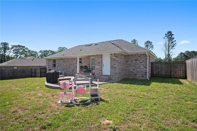 9412 Fox Hunter Ct, Semmes, AL 36575 - back of house featuring a fenced backyard, brick siding, and a lawn