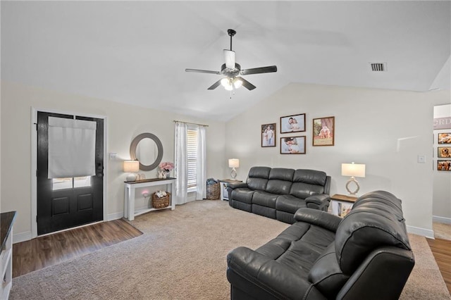 9412 Fox Hunter Ct, Semmes, AL 36575 - living room featuring carpet flooring, vaulted ceiling, baseboards, visible vents, and a ceiling fan